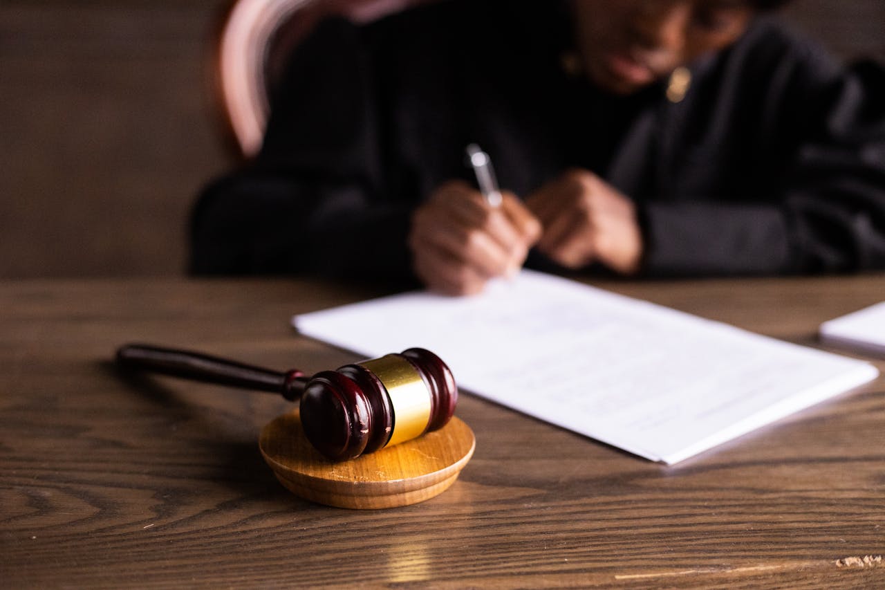 gavel-in-foreground-person-writing-in-background